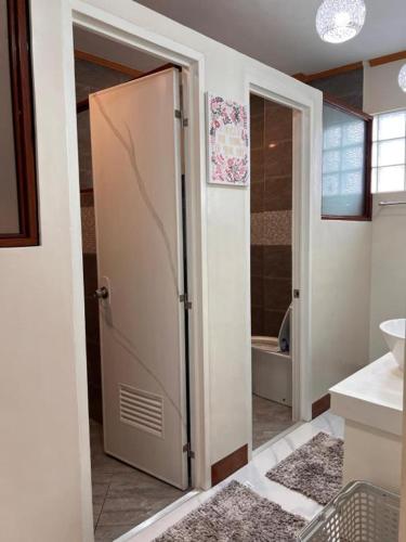 a bathroom with a door open to a bathroom with a tub at Spacious Seaview Studio in Lila, Bohol in Lila