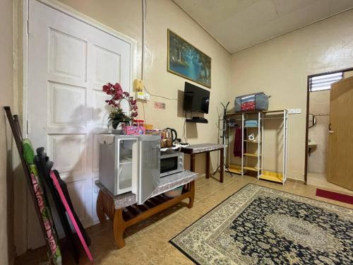 a living room with a microwave on a table at Nurjannah Roomstay Arau in Kampung Mata Ayer