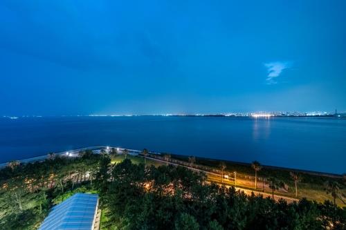 a view of a large body of water at night at Hilton Tokyo Bay in Urayasu