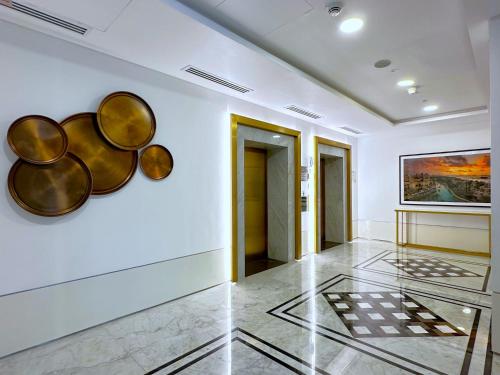 a hallway with white walls and a painting on the wall at MegaLuxury Flat Resort, Amazing Pool, Burj direct View in Dubai