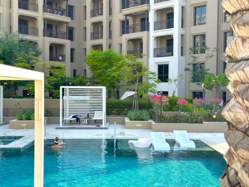 a person in a swimming pool in a building at MegaLuxury Flat Resort, Amazing Pool, Burj direct View in Dubai
