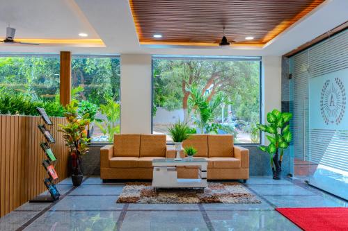 a lobby with two couches and a table at Hotel Aerotel,Hyderabad in Shamshabad