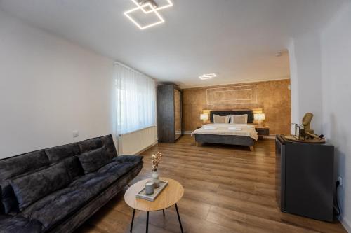 a living room with a couch and a bed at Central House by Amelie in Sighişoara