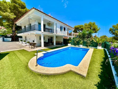 a house with a swimming pool in front of it at Chalet con piscina privada en Alcocebre in Alcossebre
