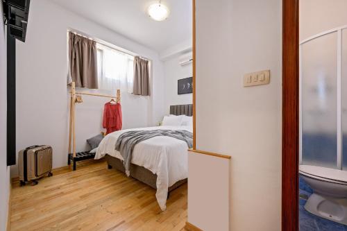 a bedroom with a bed and a toilet at Yellow house with private parking in Split