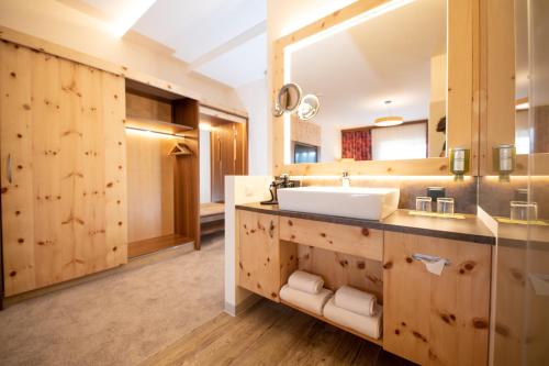 a bathroom with a sink and a mirror at Thermenhotel PuchasPLUS Stegersbach in Stegersbach