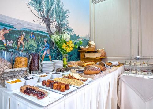 a buffet of food on a table in a room at Hôtel & Spa Le Bouclier D'or in Strasbourg