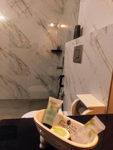 a bathroom with a bowl of toothpaste and a toilet at Villa Forever Coorg in Madikeri