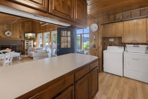 a kitchen with a white counter and a living room at Captain's Retreat in Shelton