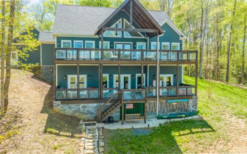 a house with a wrap around porch with a wrap around deck at Tranquility Paradise in Sevierville