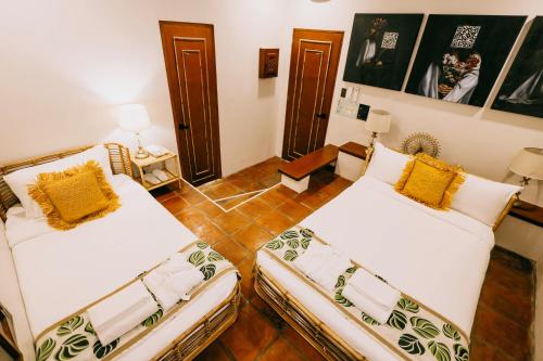 two beds sitting in a room with at Nawa Wellness in Calatagan