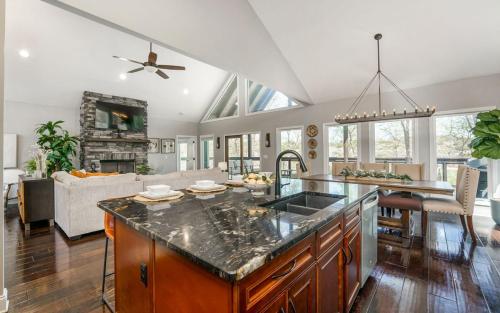 an open kitchen and living room with a large island at Tranquility Paradise in Sevierville