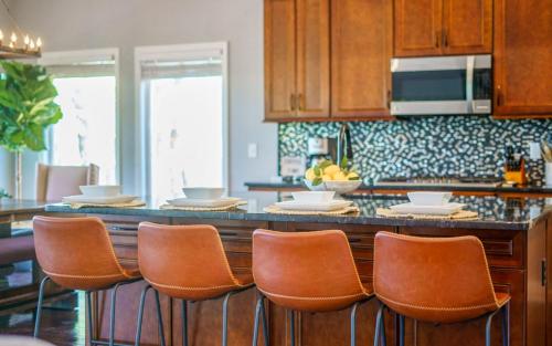 a kitchen with a bar with leather bar stools at Tranquility Paradise in Sevierville