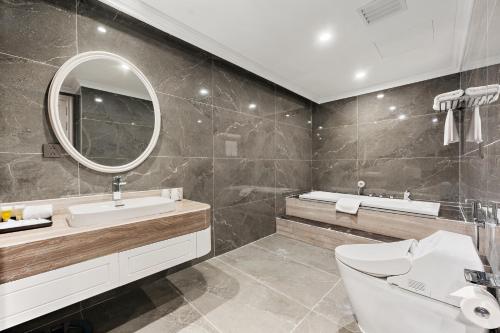 a bathroom with a sink and a mirror at Muong Thanh Luxury Cao Bang in Cao Bằng