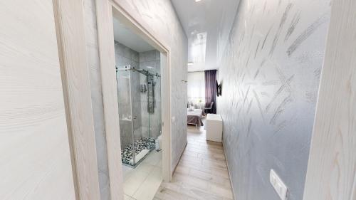 a bathroom with a walk in shower and a glass door at B&B Luxury House Rho in Rho