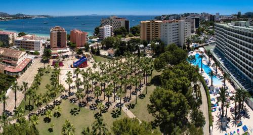 an aerial view of a resort with a pool and trees at Sol Palmanova Mallorca in Palmanova