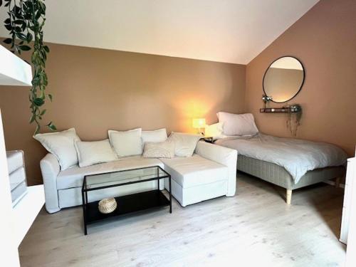 a living room with a couch and a bed at House close to World cup Trondheim 2025 in Trondheim