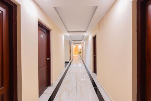 an empty corridor in a building with a hallway at Treebo Airsuite Airport Hotel in Cochin