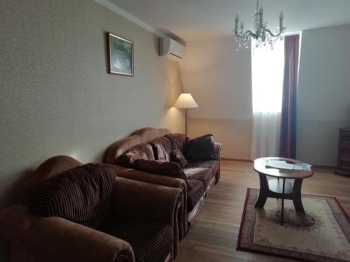 a living room with two couches and a table at Batthyány Kastélyszálló in Zalacsány