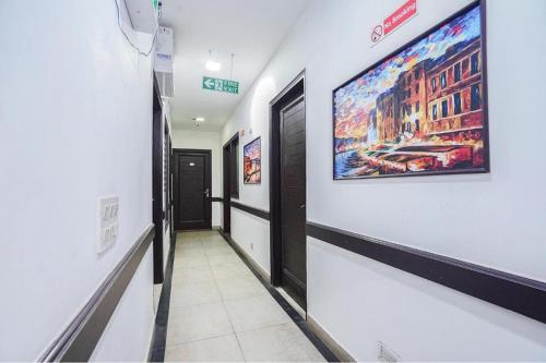 a hallway with a large painting on the wall at Hotel Kular at Saket Near PVR Cinema in New Delhi