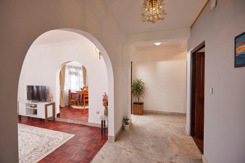 a living room with an archway and a dining room at Apartment at KTM in Bālāju