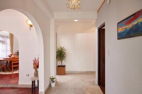 a hallway with a dining room and a chandelier at Apartment at KTM in Bālāju