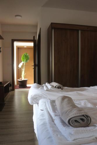 a hotel room with two beds with towels on them at Planinska Kraljica in Gornje Pale