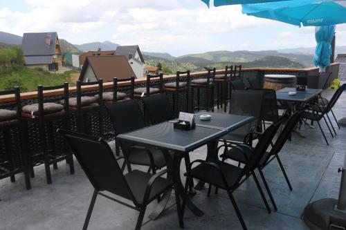 a row of tables and chairs on a patio at Planinska Kraljica in Gornje Pale