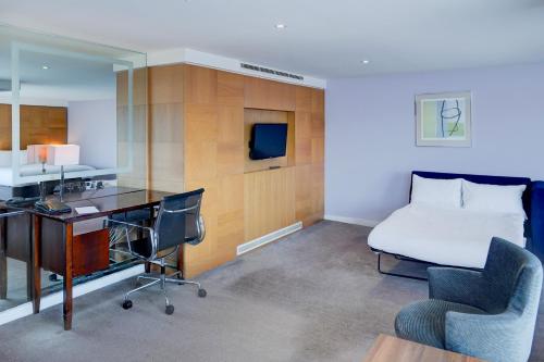 a hotel room with a bed and a desk and a bedroom at Belvilla Crewe City Centre Lifestyle in Crewe