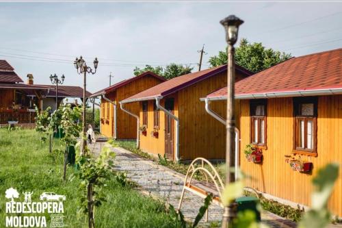 a row of wooden cabins in a village at La Nea Ion in Ţaul