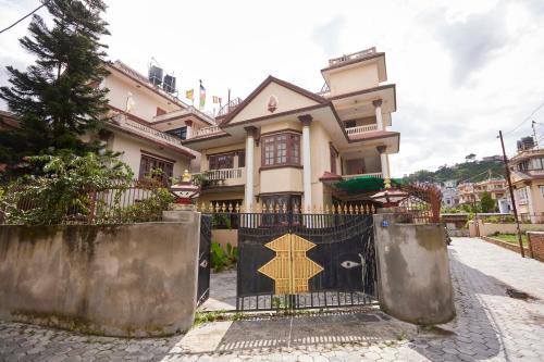 a house with a gate in front of it at Apartment at KTM in Bālāju