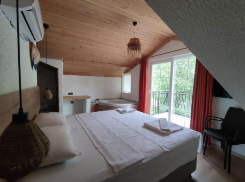 a bedroom with a large bed and a window at Güneş Boutique Hotel - Oludeniz in Oludeniz