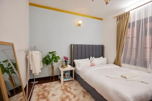 a hotel room with two beds and a mirror at Apartment at KTM in Bālāju