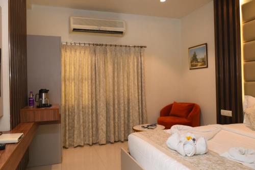 a hotel room with a bed and a chair at Hotel Annapoorna Residency in Hyderabad
