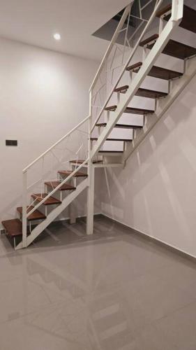 a white staircase in a white room at The Cz Retreat 2min to KTM Malaysia and Town area in Taiping