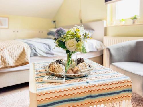 a vase of flowers on a table in a room at Modern Loft with 2 bedrooms near Sint Truiden in Herk-de-Stad
