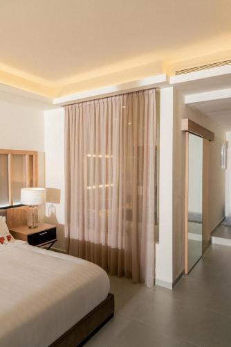 a hotel room with a bed and a window at Hotel Saint Georges Beirut in Al Marfaʼ