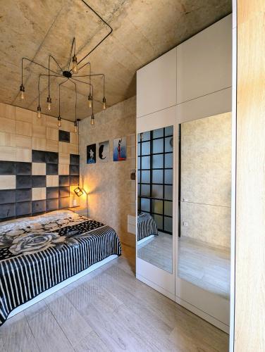 a bedroom with a large bed and a walk in closet at Apartment in bagebi in Tbilisi City
