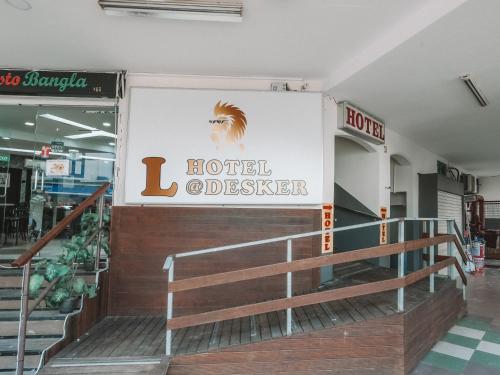a sign for a hotel outlet in a mall at A Hotel Desker in Singapore