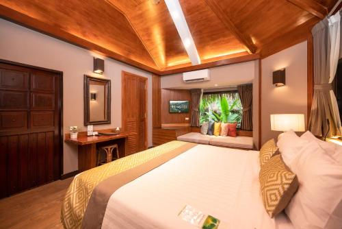 a bedroom with a large bed in a room at River Kwai Resotel in Sai Yok