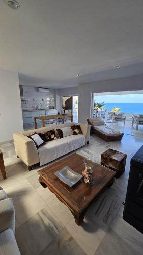 a large living room with two beds and a table at La Herradura 3 bedroom apartment in La Herradura