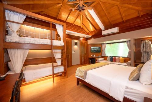 a bedroom with two bunk beds in a house at River Kwai Resotel in Sai Yok