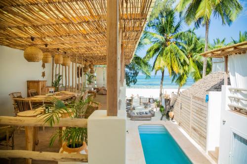 a resort with a swimming pool and a beach at Boho Boutique Hotel - Beachfront , Adults Only , Private Pool in Kiwengwa