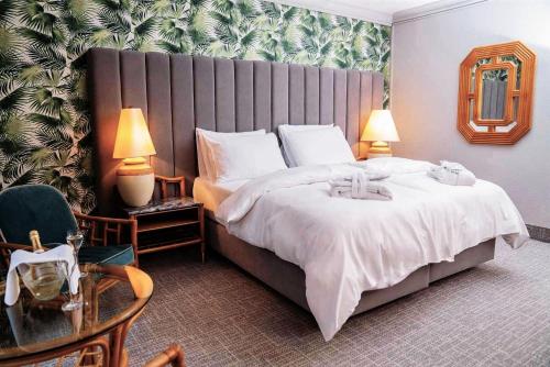 a bedroom with a large bed with a large headboard at Eventhotel Pyramide in Vösendorf