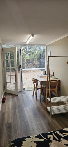 a room with a table and a dining room with a view at Almost Off Grid Tranquillity in Katherine