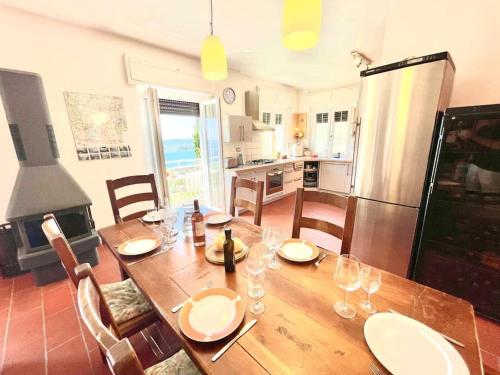 a kitchen with a wooden table with wine glasses at Villa Licia in Gardone Riviera
