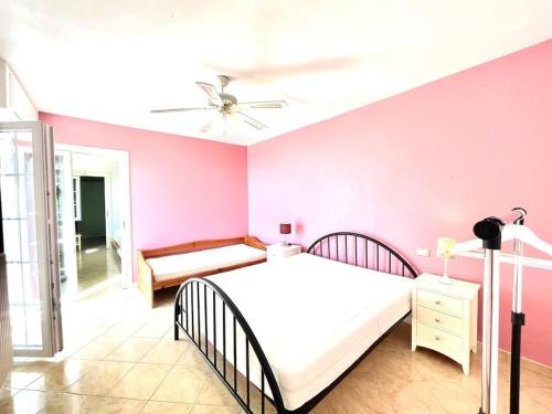 a bedroom with a bed and a ceiling fan at Villa Licia in Gardone Riviera