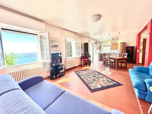 a living room with a blue couch and a table at Villa Licia in Gardone Riviera