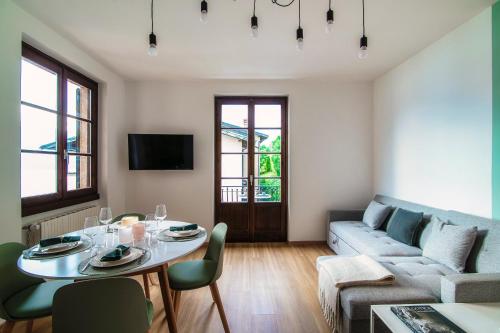 a living room with a table and a couch at Agastache & Salvia - by MyHomeInComo in Menaggio