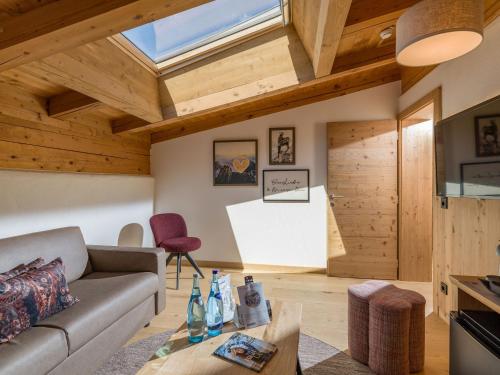 a living room with a couch and a table at Hotel & Spa Sonne 4 Sterne Superior in Kirchberg in Tirol